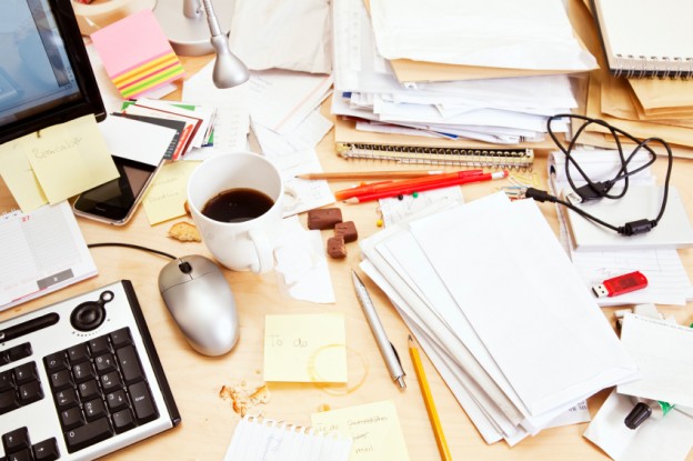 Office table with papers, pens, coffee mug