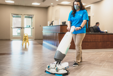 ServiceMaster Clean employee cleaning a hard surface floor